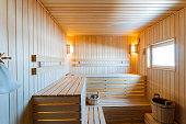 Hardwood sauna building with wood stain, benches, and a window fixture