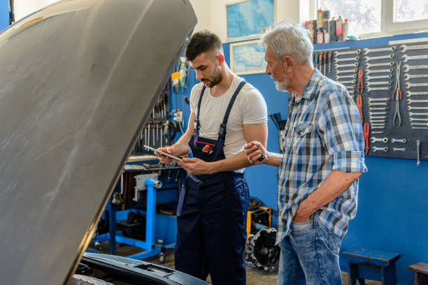 istock An Auto Mechanic is Repairing a Car Explaining Car Problems to a Senior Customer. 2101567293