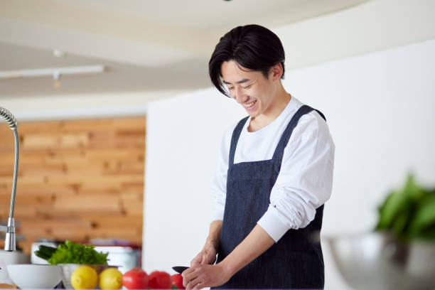 istock Young Japanese man cooking in the kitchen 2101584697