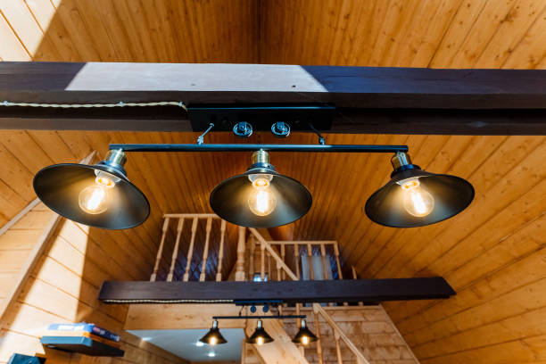 istock Wooden ceiling with three lights suspended, creating a warm and cozy atmosphere 2101600850