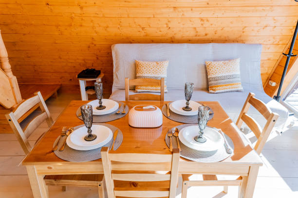 istock Wooden dining table with tableware in a living room 2101600852