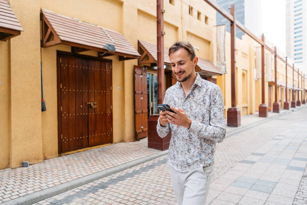 istock Young Man Using Phone At Souk Al-Mubarakiya Market In Kuwait City 2101618683