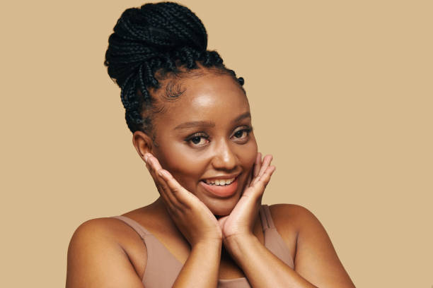istock Smiling Black Woman Touching Face 2101619742