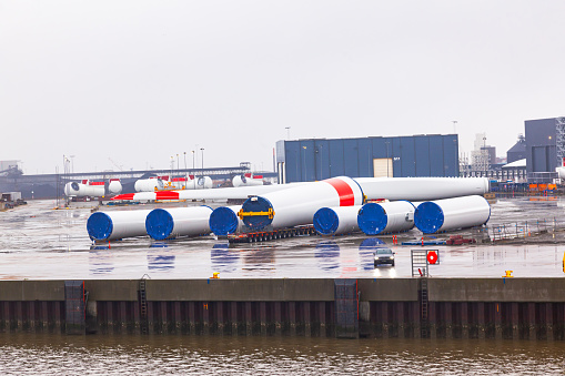 Onshore storage of blades and parts for wind generators at a seaport in Germany.