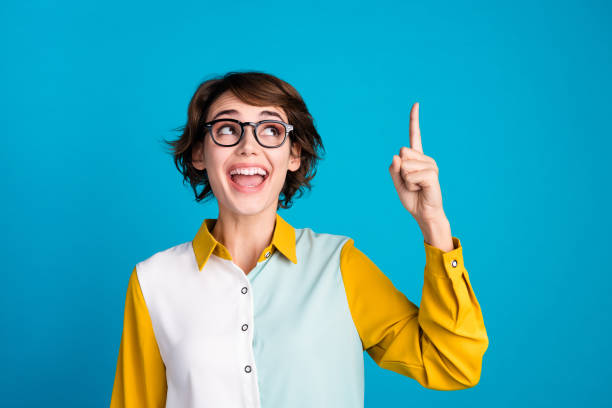 istock Portrait photo of excited student lady direct finger up genius plan find solution math task look novelty isolated on blue color background 2101631002