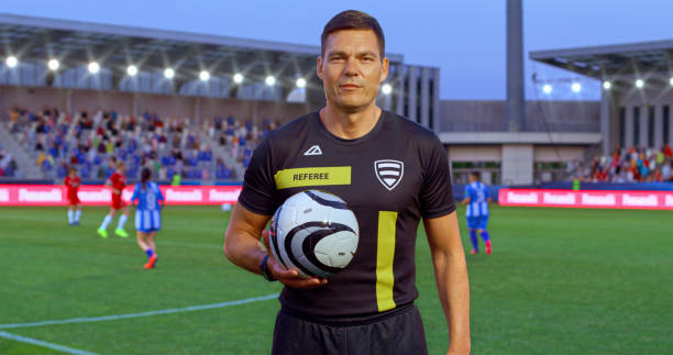 istock Football referee holding football 2101641057
