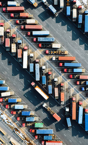 istock Aerial View, Rows of Trucks Driving in Harbor with Trailers 2101679702