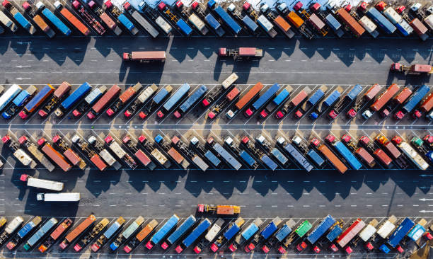 istock Aerial View, Rows of Trucks Driving in Harbor with Trailers 2101680231