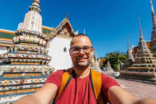 istock Young Man Taking Selfies At Wat Pho (Temple Of The Reclining Buddha) In Bangkok In Thailand 2101680245