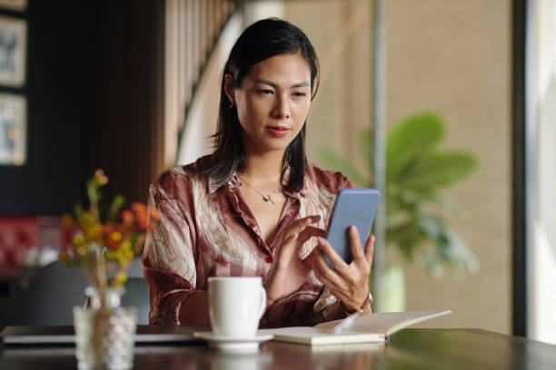 istock Businesswoman Checking Emails on Smartphone 2101699444