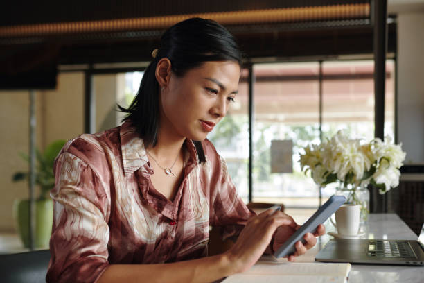Businesswoman Checking Messages from Colleagues