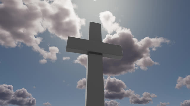 A huge Christian cross against the backdrop of moving clouds.