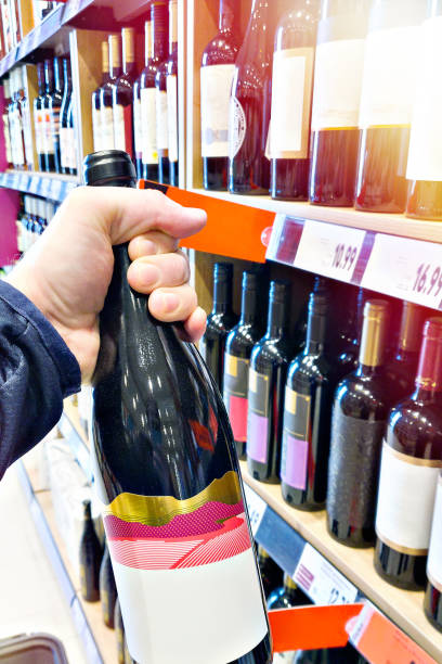 istock Bottle of red wine on hand 2101706882