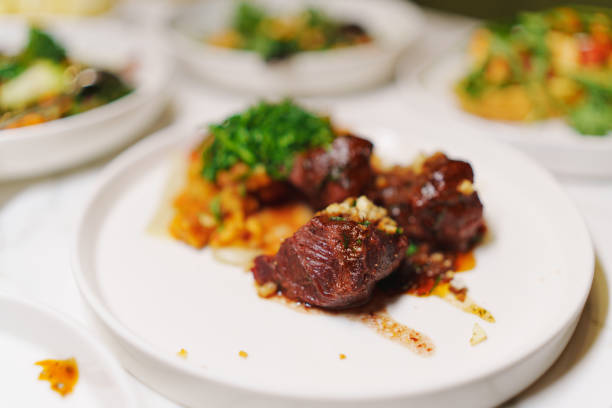 Grilled Steak Striploin and Pepper sauce on cutting board on dark wooden background