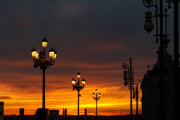istock Streetlight illumination with a red sky at sunset 2101713385