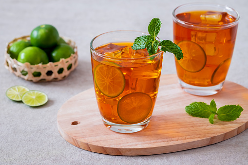 Iced tea with lime and mint leaf