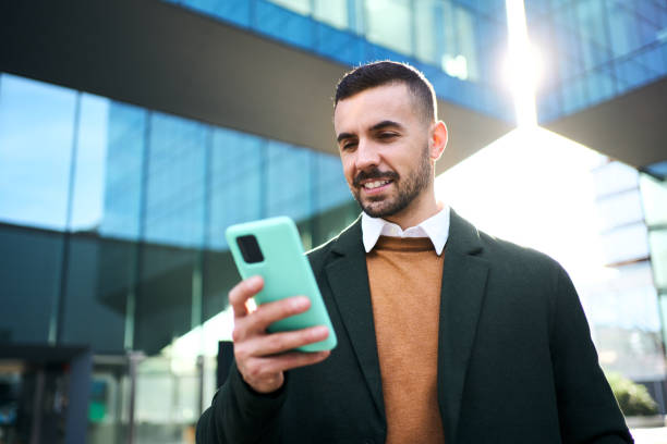 istock A young Caucasian man in a formal suit standing in front outside an office building 2101746756