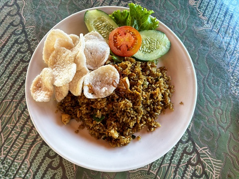 a plate of fried rice with crackers ready to be enjoyed