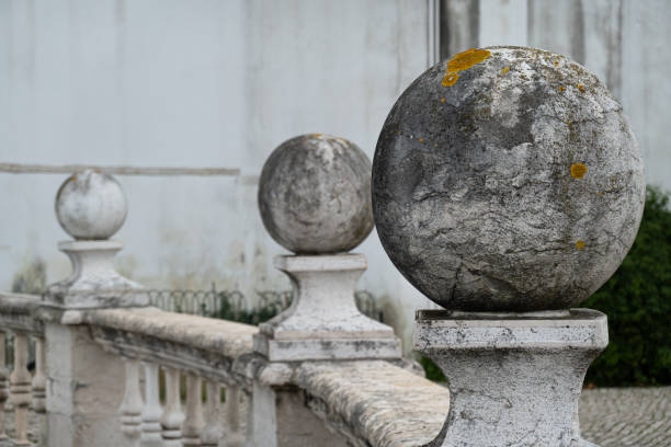 Decorative stone spheres on pedestals on railing in Lisbon park Spheres of granite placed on pillars on balcony railing in public park in Lisbon in Portugal baseball rundown stock pictures, royalty-free photos & images