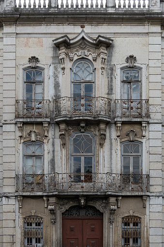 Detailed architectural view of classic historic facade of abandoned palatial building in the centre of Lisbon in Portugal