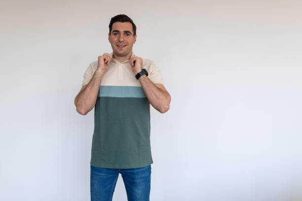 Portrait of a mid adult Caucasian man gesturing in front of a white wall in an apartment