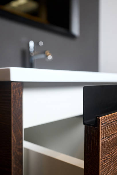 istock Sliding lockers with aluminum extruded G profile handles for bathroom kitchen cabinets made of Chipboard CPD particle board particleboard LDSP under basin cabinet corner and table top closeup 2101807028