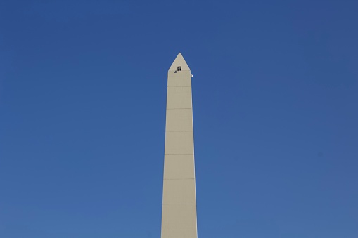 Washington Monument is an obelisk near the west end of the National Mall in Washington, D.C., built to commemorate the first U.S. president, General George Washington. The monument, made of marble, granite, and sandstone, is both the world's tallest stone structure and the world's tallest obelisk, standing 555 feet 5 inches (169.294 m).  It was designed by Robert Mills, an architect of the 1840s.