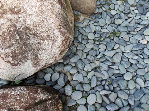 Gray gravel and granite stone create a textured background, adding depth and character to any design or project