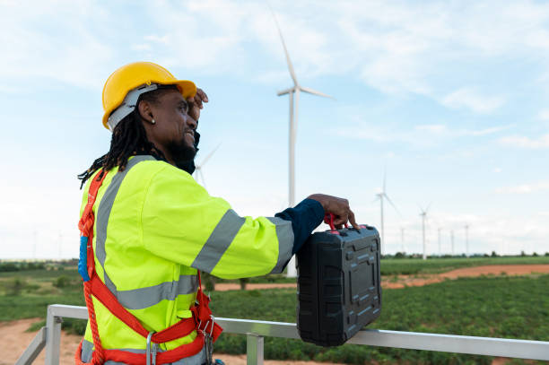 istock Portrait of smart engineer with protective helmet at electrical turbines field 2101894677