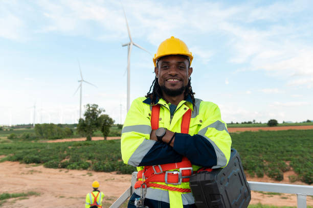 istock Portrait of smart engineer with protective helmet at electrical turbines field 2101895202