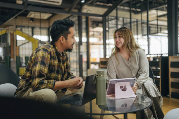 istock Two professional employees brainstorm ideas and meeting plans and discuss projects at work. 2101899517