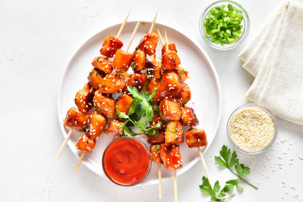 istock Teriyaki chicken skewers on plate 2101903226