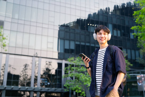 istock Asian man listening to music 2101908062