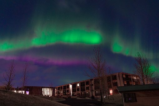 Some buildings illuminated by bright auroral northern lights