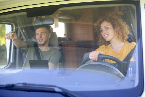 istock Young couple driving a RV 2101937762