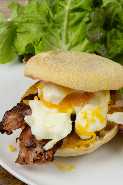 istock Two homemade English muffins with fried egg and cheese breakfast on a plate 2101951454