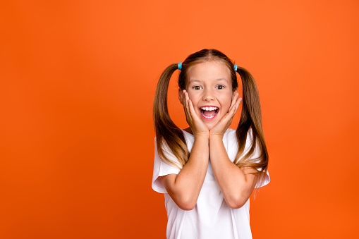 Cute girl in diadem on red background. Little princess