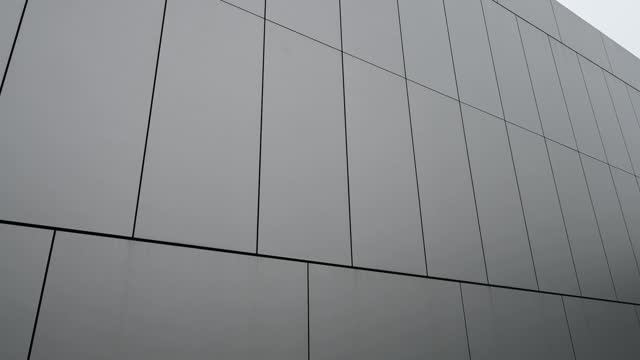 Low angle video of a corner of modern gray metal architecturere