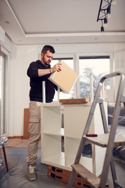 istock Man working and assembling furniture in a new apartment. 2102018940