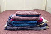 A stack of towels on a bed