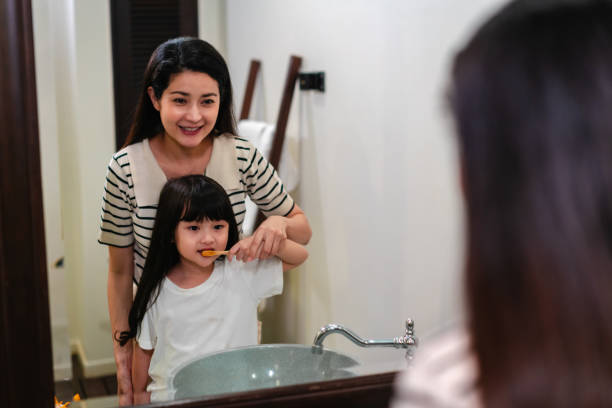 istock Mother Teaching Daughter Dental Hygiene 2102037187