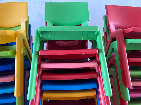 Colourful small plastic benches are neatly arranged
