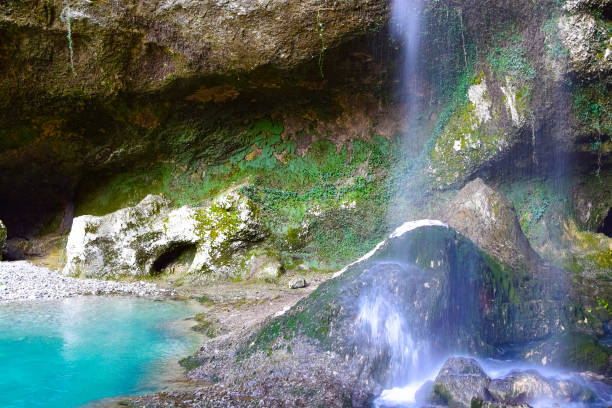 istock Waterfall in a gorge among the rocks. 2102050831