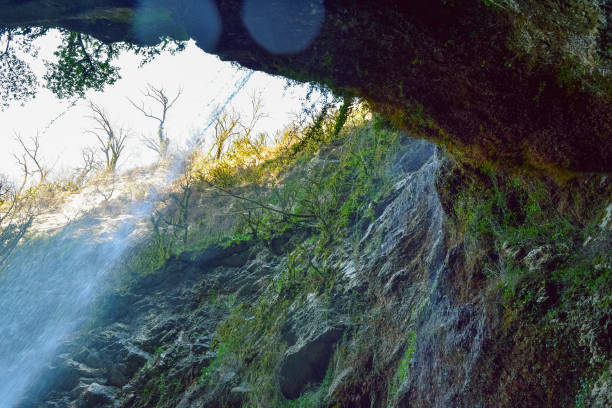 istock Under the waterfall. Waterfall among rocks in a mountain gorge. 2102051372