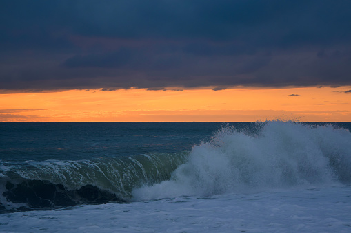 Big waves on the sea at sunset. Beautiful seascape. The sea is stormy.