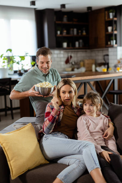 istock Family Movie Night: Engrossed in Thrilling Scenes at Home 2102070589