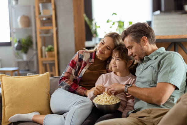 istock Family Movie Night: Engrossed in Thrilling Scenes at Home 2102070591