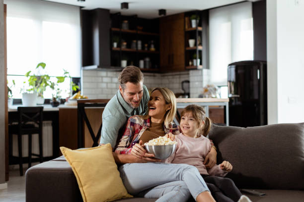 istock Family Movie Night: Engrossed in Thrilling Scenes at Home 2102070592