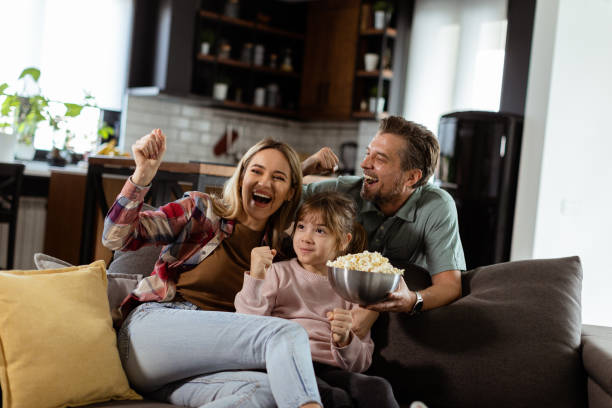 istock Family Movie Night: Engrossed in Thrilling Scenes at Home 2102070892