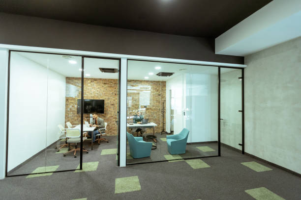 istock Focused work in a modern glass-walled office 2102083235